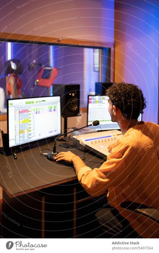 Man approving while recording vocal sound in studio audio engineer singer song music thumb up performer voice technician create produce mixer equalizer panel