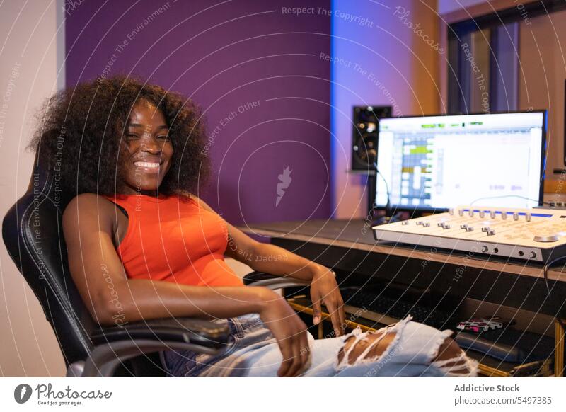 Content black woman with computer recording sound audio engineer music studio create portrait female african american technician compose production industry