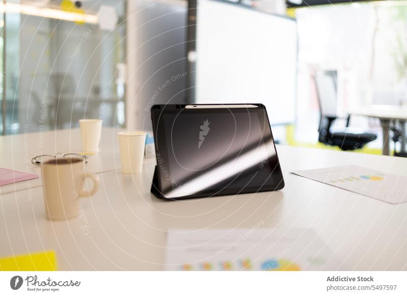 Tablet with cup of coffee on table tablet workplace desk hot drink modern mug beverage gadget office device paper workspace contemporary business tea digital