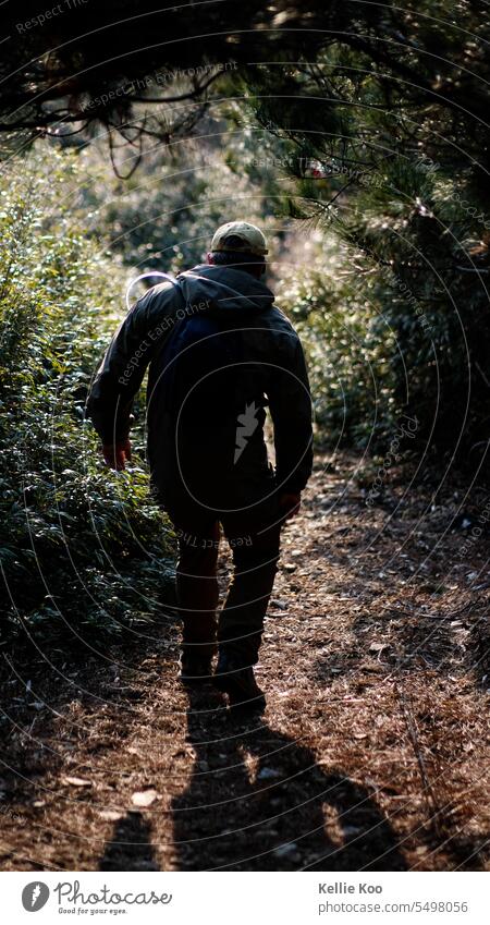 Man hiking with light backpack hike Hiker Walking Nature trekking Mountain natural light outdoors outdoor shot outdoor activity nature tourism Healthy Lifestyle