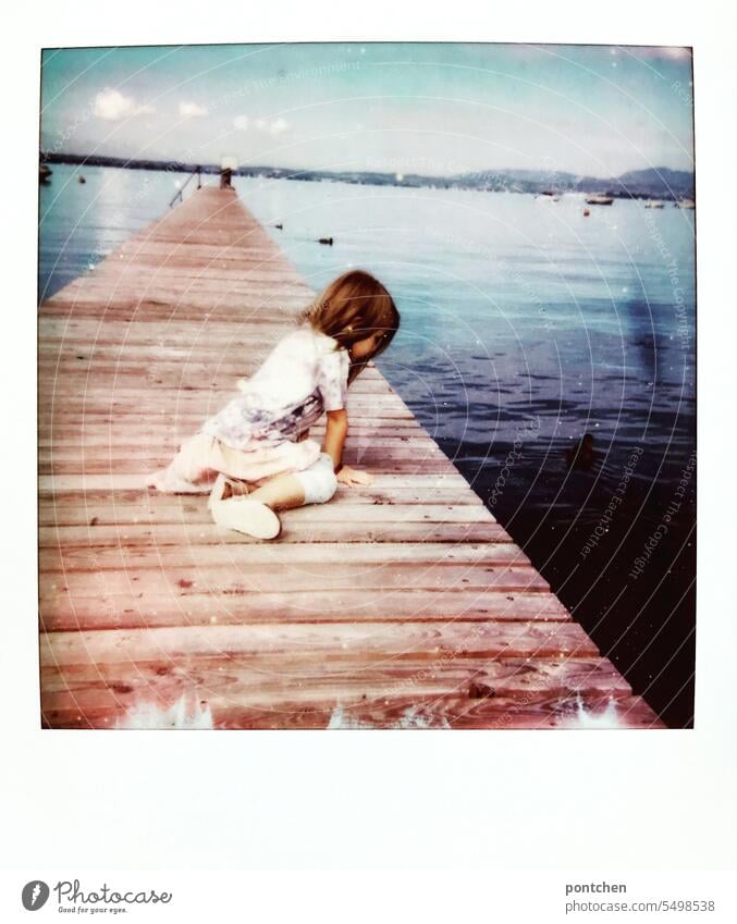 polaroid. a girl sits on a jetty and looks at the water in lake garda wooden walkway Lake Garda Footbridge Water vacation Polaroid Summer travel