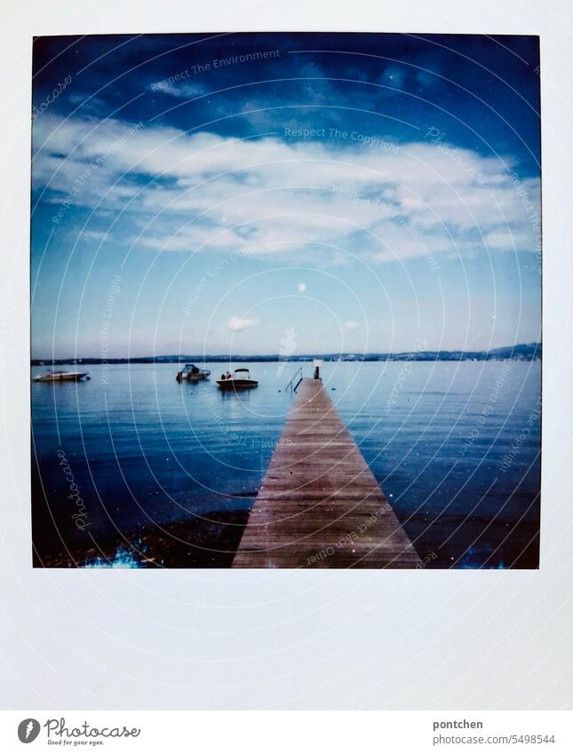 a wooden footbridge on lake garda. polaroid Polaroid Summer travel vacation Water Footbridge Lake Garda Blue wooden walkway boats Clouds Vacation & Travel