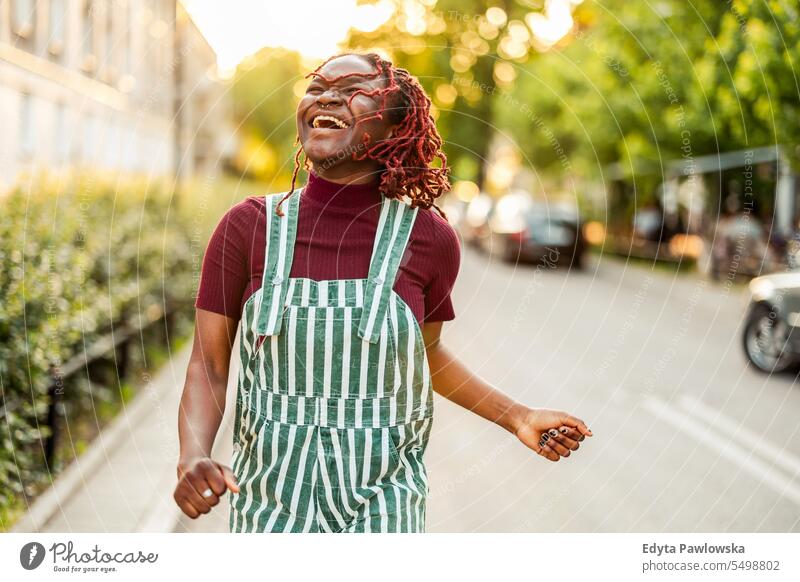 Cheerful non-binary person dancing on the street in the city real people positive confident adult young adult lifestyle authentic black African american
