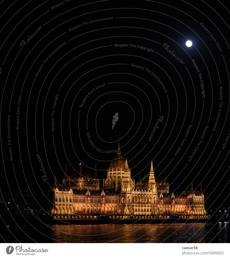 Famous Hungarian Parliament scenically illuminated at night parliament europe ancient moon full budapest iconic building hungarian government dark palace