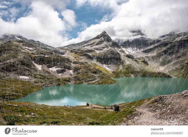 Beautiful photography of lake Weisssee in the High Tauern white alps mountain nature sky water blue travel landscape snow clouds scenic high tauern
