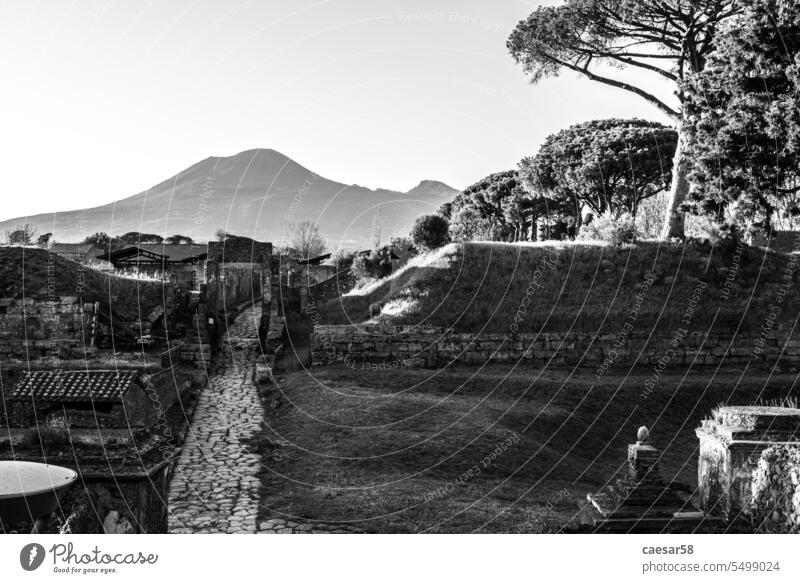 Early morning, a road leading to the ancient city remains of Pompeii, Mount Vesuvius in the background, Southern Italy black and white pompeii vesuvius view