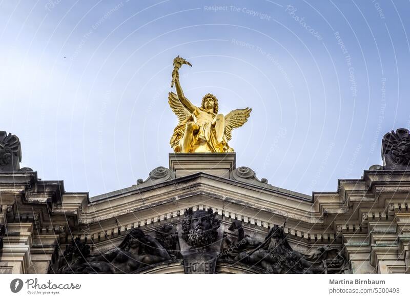 The golden sculpture of Cupido on the roof of the art academy in Dresden cupido eros male travel parts culture blue plated religion dresden spirituality torch