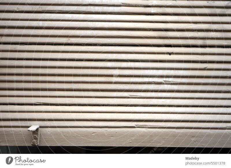 Lowered gray old shutter in front of a shop window in the alleys of the old town of Ghent in East Flanders in Belgium Roller shutter Shop window Window sure