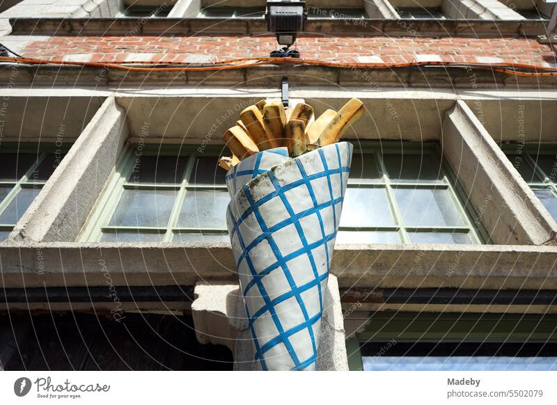 Oversized paper bag with French fries in front of a snack bar in the Hassen of the old town of Ghent in East Flanders, Belgium french fries Paper bag Snack