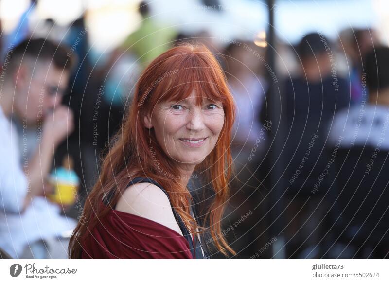 Drinkje bej inkje | portrait of smiling woman 50+ with beautiful long red hair Woman Looking into the camera Central perspective Shallow depth of field Day