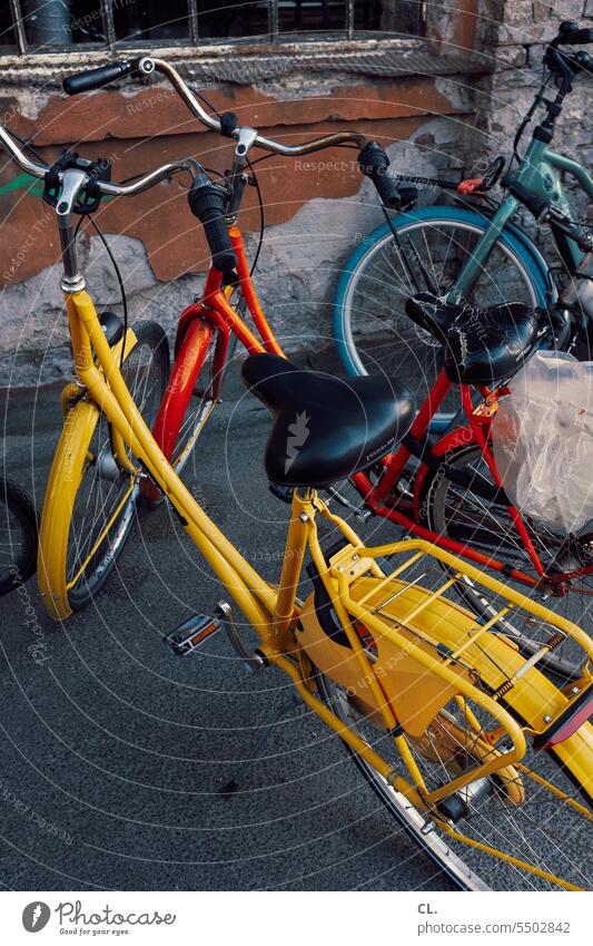Colorful bikes Bicycle Cycling Means of transport Mobility Yellow Orange Blue Transport Road traffic Saddle Parking luggage carrier turnaround