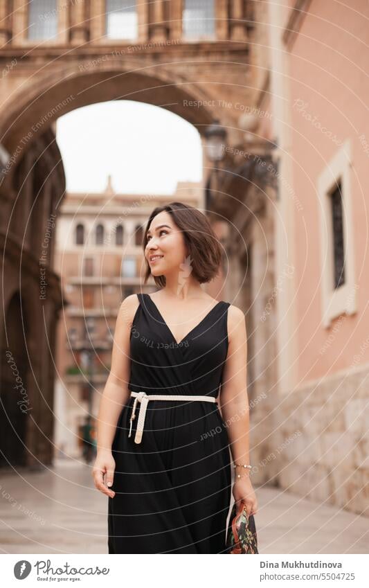 retro portrait of a smiling woman closeup. Beautiful woman at street of historic town. Gorgeous girl sightseeing in Europe. Confident woman, solo female traveler. Glamour and chic, fashion and style concept.