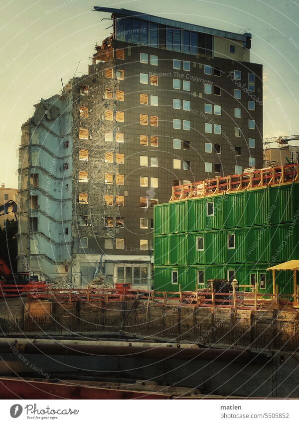Evening sun in demolition house Back-light condemned house High-rise Exterior shot Container Construction site Deserted Sky boarding Berlin