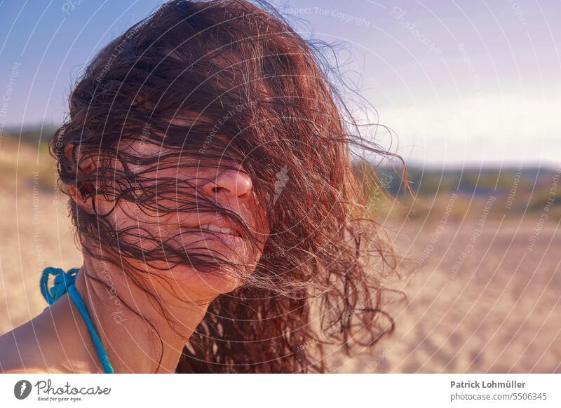 Hair face Woman feminine hair long hairs Face portrait gesichtwild Brunette black hair Wind Mature ü50 50+ Healthy menopause Feminine Head Beach out Relaxation