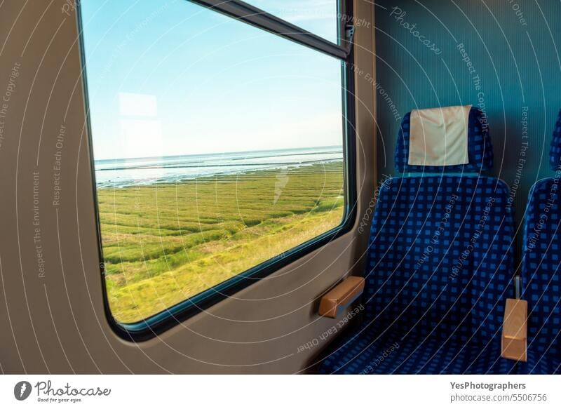 Train traveling to Sylt island, in Germany. Window view with Wadden Sea and swamp Transportation beach beautiful blue chair coast color concept destination