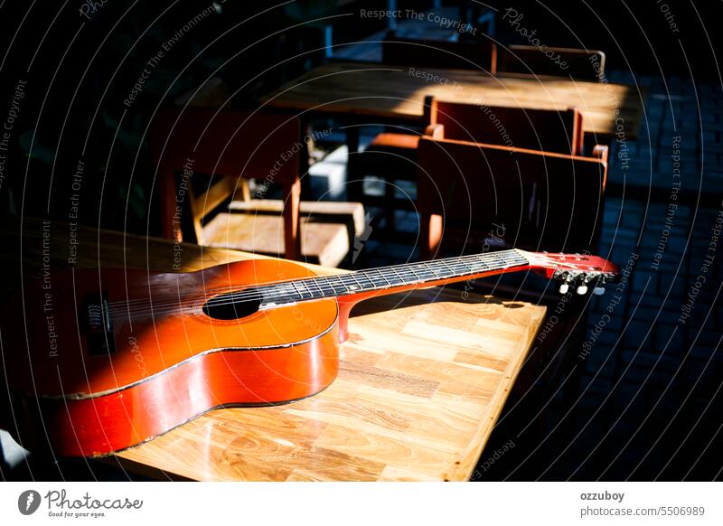 Acoustic guitar lying on the table in the sunny day music acoustic instrument string wood sound background object melody musical art brown wooden classic