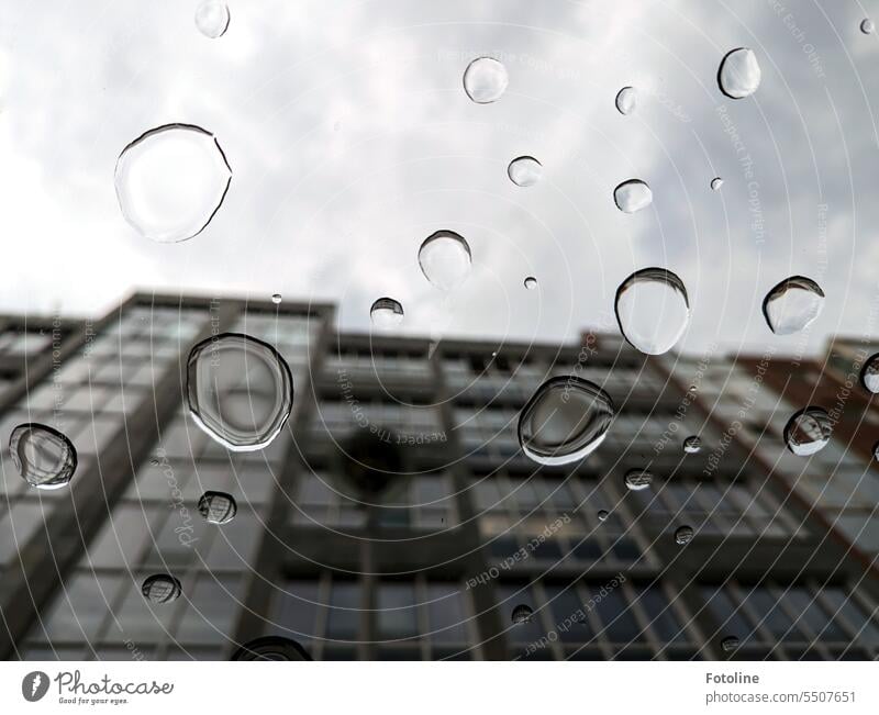 Looking up through a fully dripped window and seeing the gray of the city a little more exciting. Drop Water Drops of water Rain Wet Close-up Detail raindrops