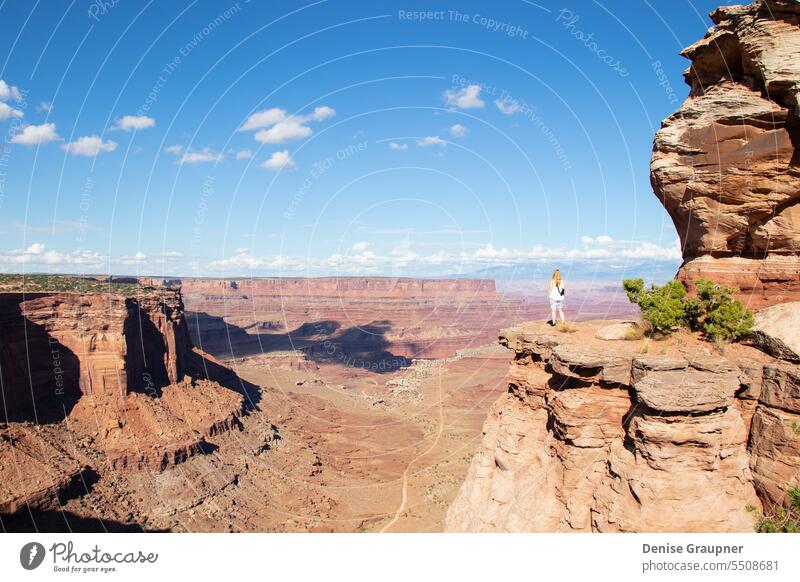 A woman looks in Canyonlands National Park USA utah canyonlands hiking moab usa travel nature landscape wilderness viewpoint vista person hike desert tourism