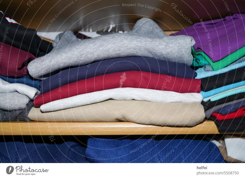 View in the closet, colorful sweaters and T-shirts folded together Closet Clothing Hang garments Hanger Arrangement textile Shirt Outfit Fashion Collection