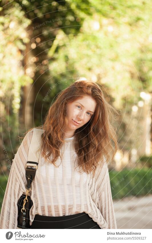 candid portrait of young beautiful woman in summer. Pretty ginger girl with red hair. park smiling happy pretty Smiling cheerful attractive Woman Park Lifestyle