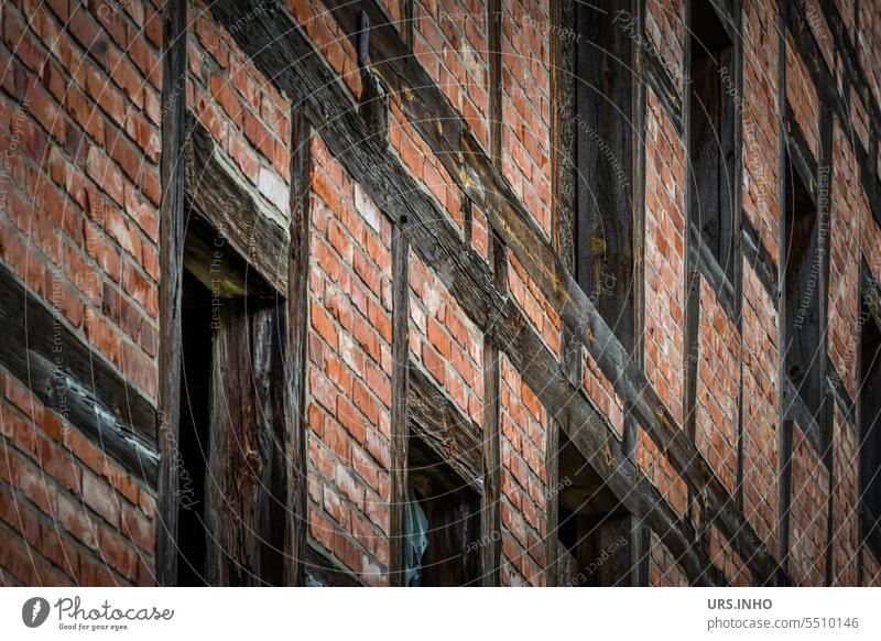 Facade of old half-timbered house with red bricks between the dark wooden beams Half-timbered house History of the Historic Building Ancient Joist