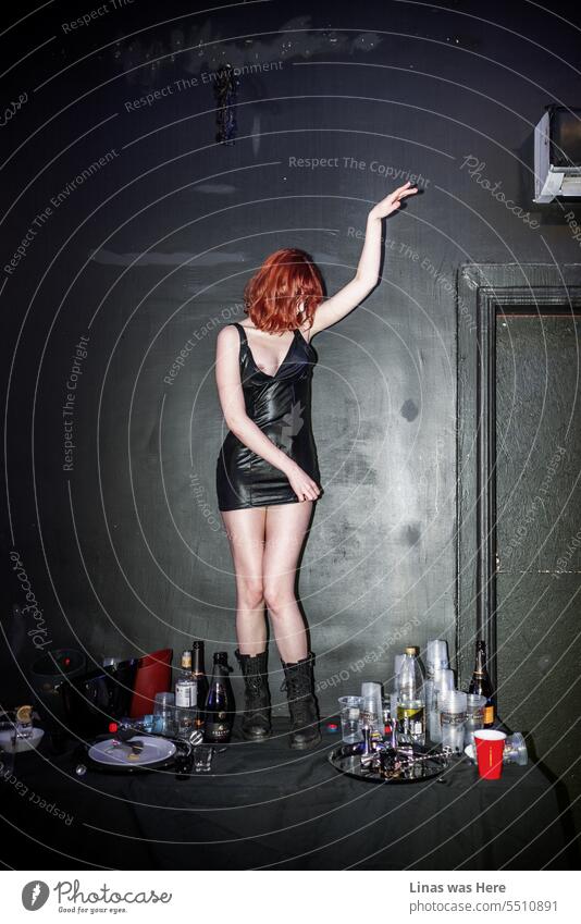 It’s never boring with a wild and gorgeous red-haired dancer making chaos all around her. Her sexy black dress fits her well. Dancing on a messy table is not an issue. And a bit of a nipple slip is making the temperature rise even more in this one.