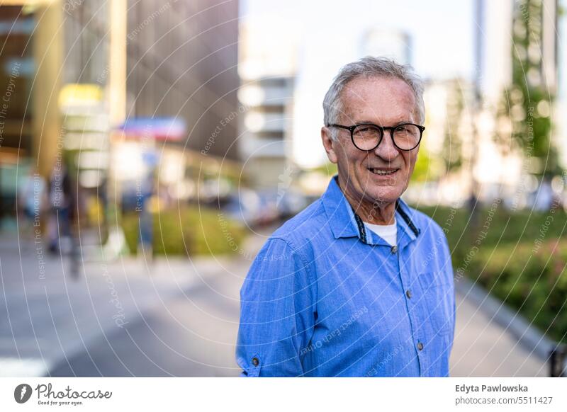 Portrait of mature man standing in the city people caucasian healthy city life gray hair enjoy street casual day portrait outside real people white people adult