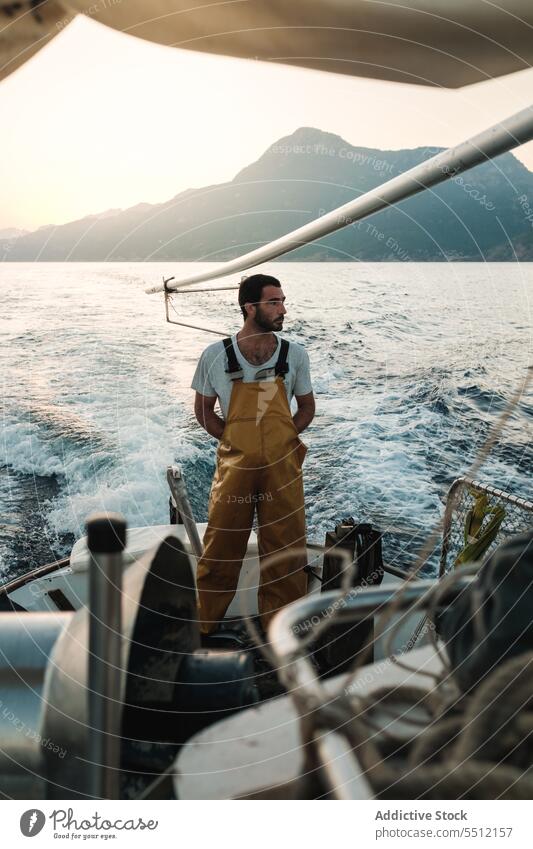 Thoughtful seaman enjoying spectacular view from fishing boat in sunset fisher sail admire seascape male soller balearic islands mallorca fisherman sailor