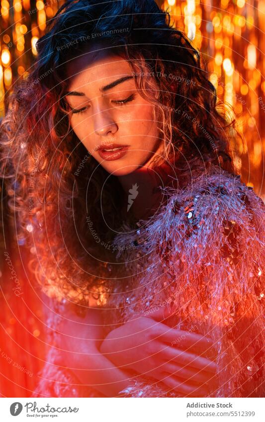 Attractive woman with curly hair in room with neon lights portrait effect illuminate dot calm peaceful tranquil sensual young female lady long hair human face