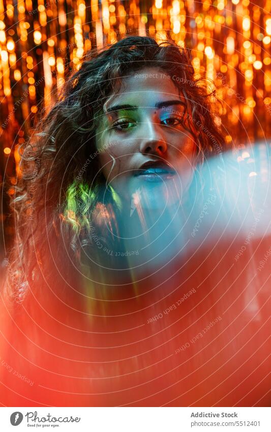 Attractive woman with curly hair in room with neon lights portrait effect illuminate dot calm peaceful tranquil sensual young female lady long hair human face