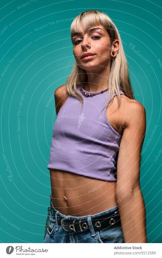 Confident woman with looking at camera hipster portrait natural body accept studio shot confident self confident self assured female young blond bangs piercing