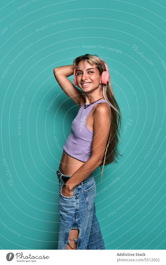 Young happy female listening to music in studio woman headphones smile song studio shot playlist free time delight meloman young blond casual glad style top