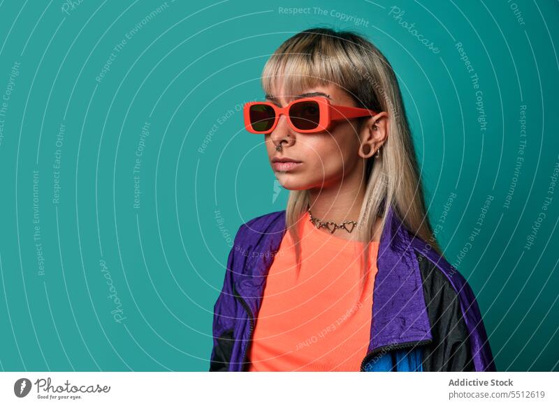 Confident trendy hipster woman in sunglasses street style posture studio shot informal subculture confident self confident self assured unemotional cool female