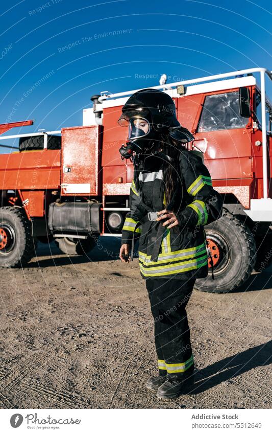 Firefighter in uniform and mask woman respirator protect vehicle prevent firefighter female safety equipment occupation professional workwear transport danger