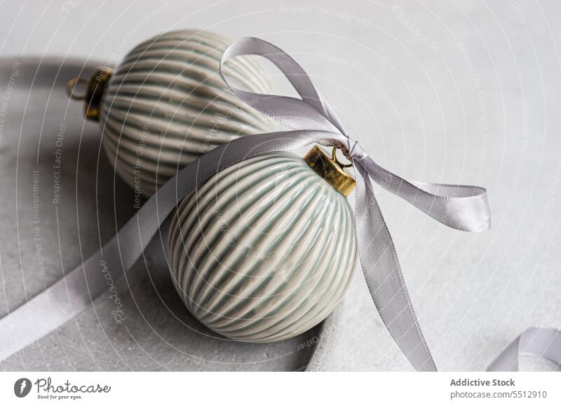 Christmas baubles on grey surface christmas ribbon symbol tradition ball festive new year bow decoration holiday xmas celebrate decorate december element event