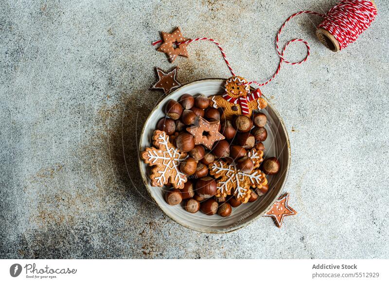 Plate of chestnuts with Christmas cookies christmas plate gingerbread thread dessert holiday food celebrate tasty xmas delicious yummy festive sweet pastry heap