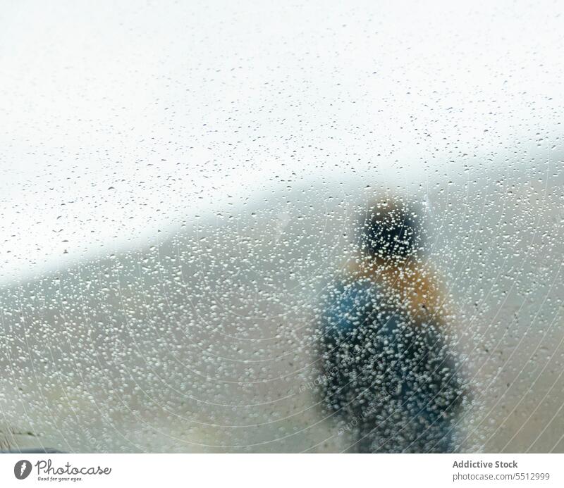 Person behind glass with drops in mountains person window alone solitude autumn nature fall weather wet overcast through glass france alps french alps cold