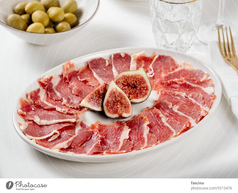 Jamon on a plate with figs jamon ham appetizer food restaurant delicious meat pork gourmet snack cured delicatessen prosciutto background sliced hamon smoked