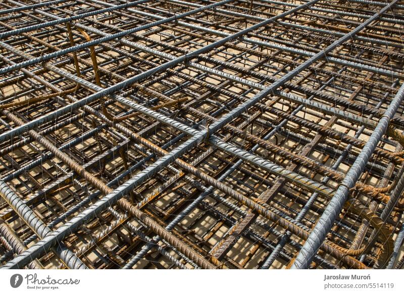 Reinforcement mesh background texture form design pattern ribbed reinforcement bars construction site steel concrete works structure industry building stacked