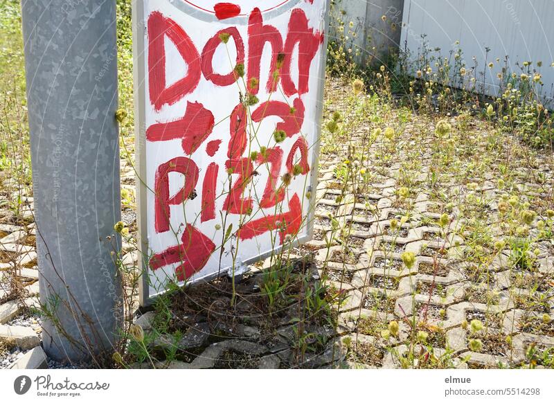 handwritten sign with red writing - kebab & pizza - standing next to a metal bar and on grass pavement Kebab Pizza hunger Kebab stand Pizza stand Turkish food