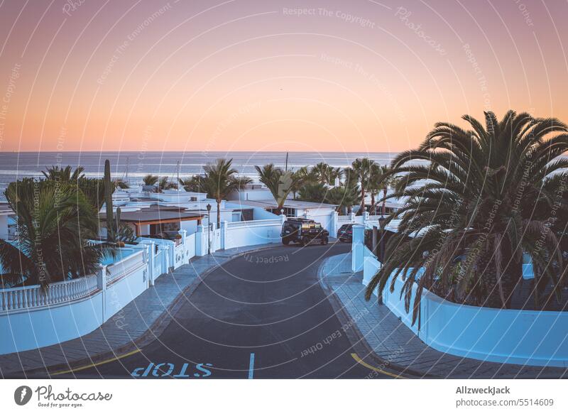 a street, houses and a beautiful sea view at sunset in Lanzarote Island vacation Vacation photo Vacation destination Vacation mood Summer Summer vacation Sunset