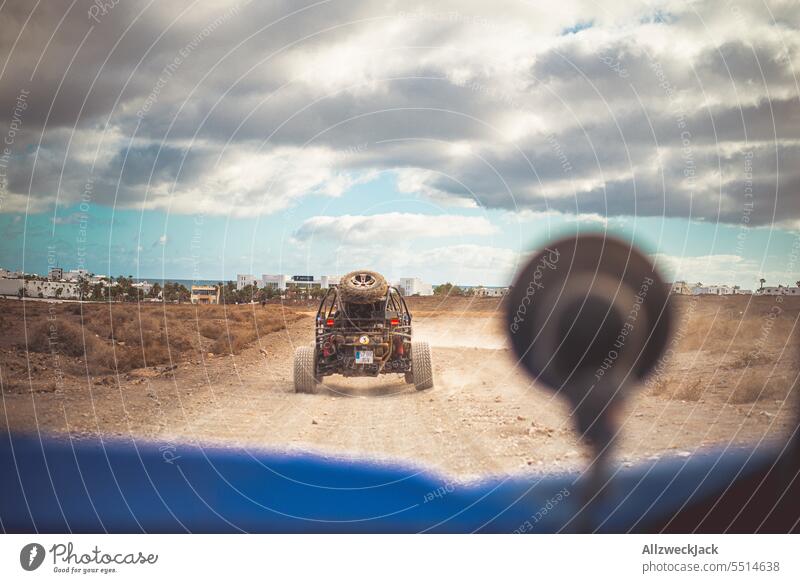 Camera perspective from a buggy during an offroad ride Summer Summer vacation Offroad Buggy outdoor mogul slope Dust Cloud of dust Dusty route
