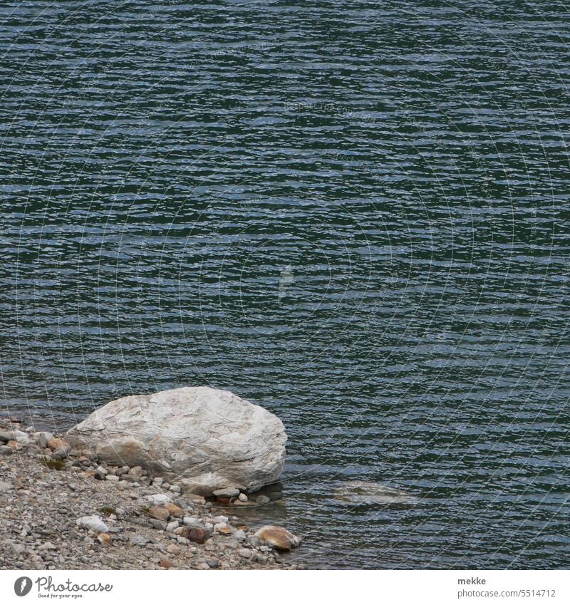 Lonely and quiet on the shore Stone Lake bank Water Lakeside Surface of water Peaceful Reflection Relaxation Nature Environment Calm tranquillity Idyll Waves