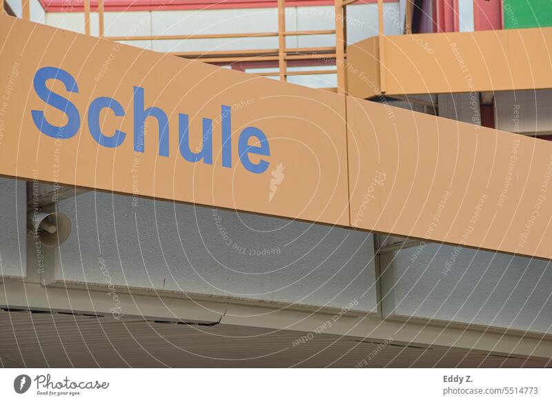 Lettering with the word school on a metallic-looking, slightly faded orange grid-like structure running diagonally. School School building Education