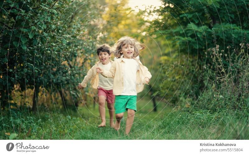 Kids playing running on plot in country house. Ecological life outside city adorable backyard beautiful boy cheerful child childhood children europe fall family