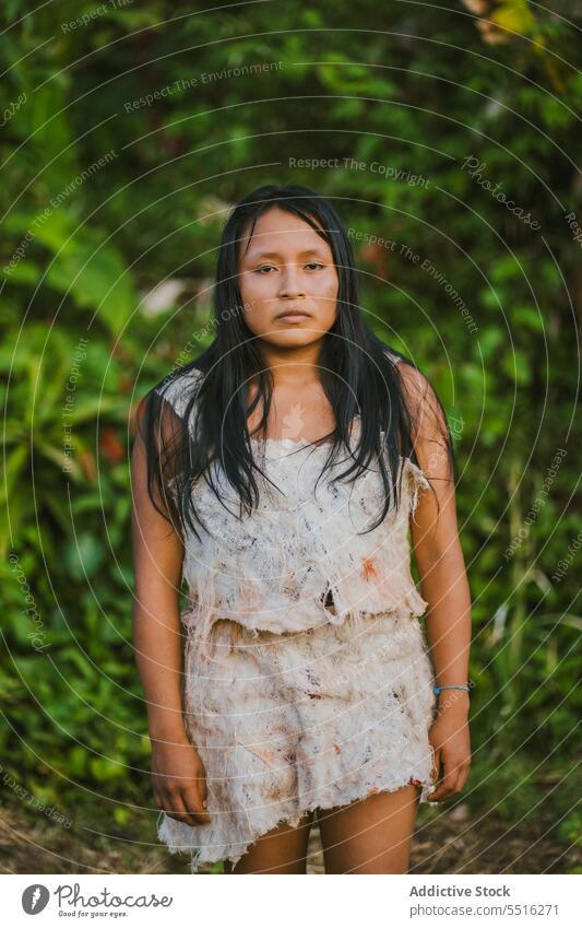 Serious woman with paint on face nature forest serious culture tradition green summer authentic female woods tribal plant environment floral woodland natural
