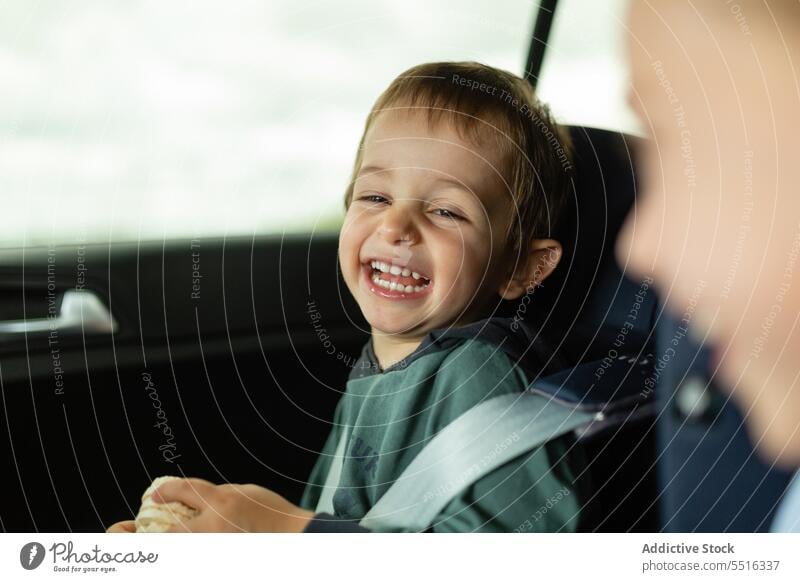 Children laughing while sitting in car seats boy child belt vehicle kid transport casual daylight childhood automobile daytime passenger vacation summer fasten