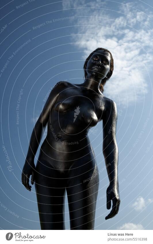 It’s a hot day outside. The sky is blue. And a gorgeous naked girl is all covered in black body paint and sweating gracefully. She looks surreal and supernatural. But this type of alien abduction definitely pumps up the temperature.