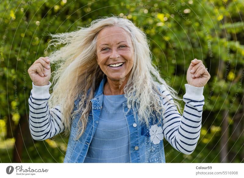 Happy Woman caucasian retirement one cheerful looking camera standing laughing satisfied best ager expression pensioner emotion adult enjoy beautiful middle age