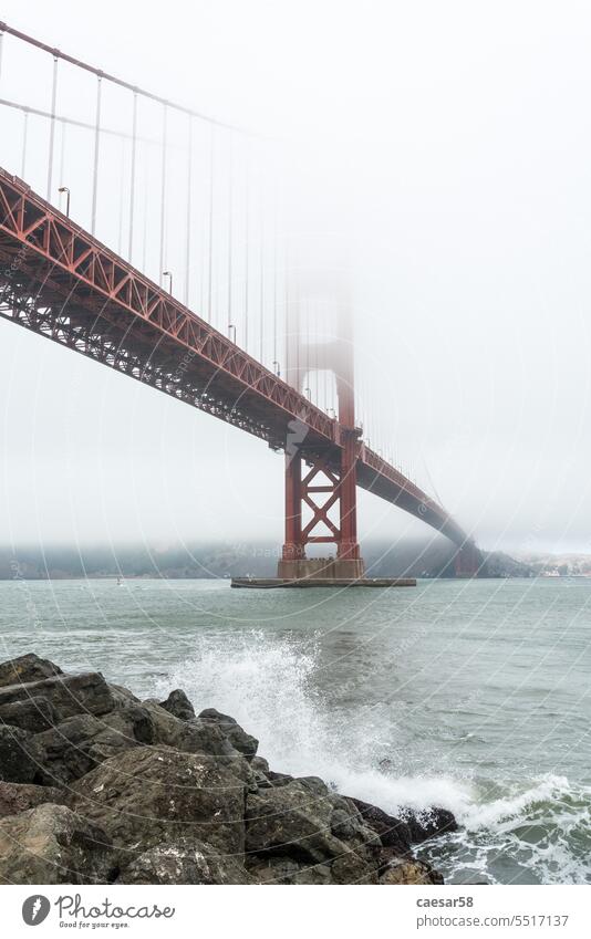 Scenic Golden Gate Bridge in the fog from Fort Poin, San Francisco bridge wave shore magnificent white storm wind golden gate bridge san francisco symbol coast